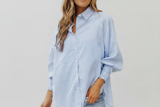 This beautiful and versatile blue striped blouse is a must for any boutiques inventory.  Pairs will with neutral palettes.